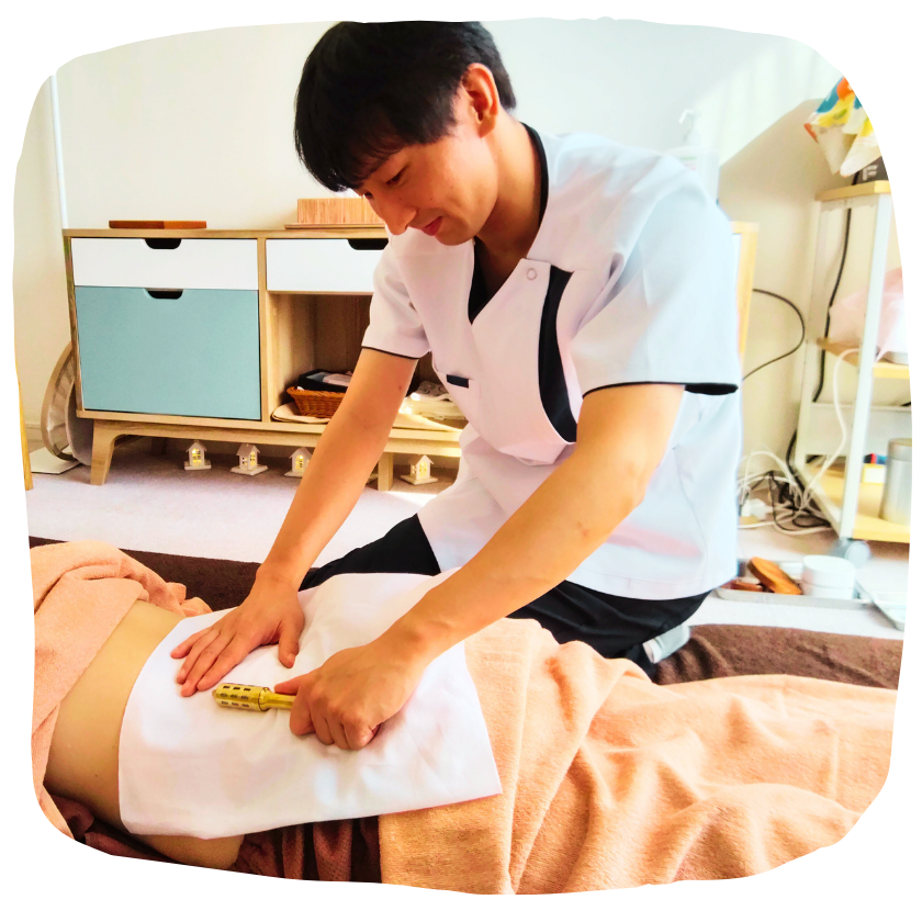 坐骨神経痛のしびれに対し、温灸でやさしく血流を促す笑顔鍼灸院の施術風景
